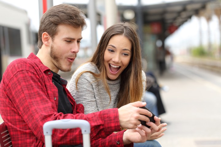 couple smiling at phone
