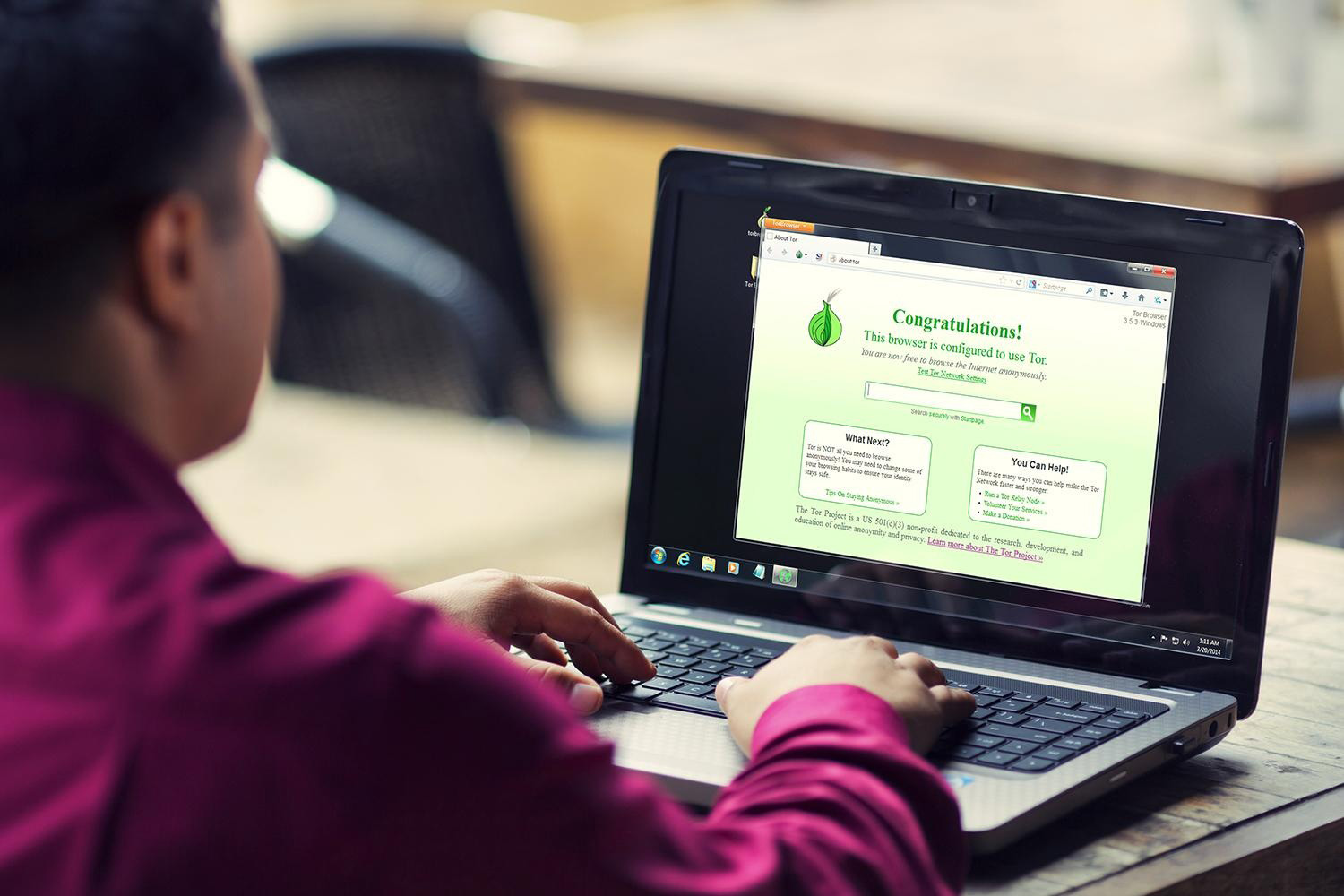A person using a browser that is configured to use Tor, on a laptop.