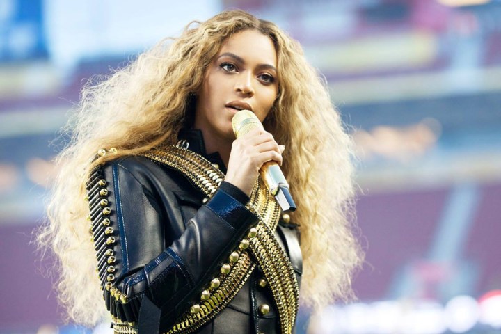Beyonce holds a mic and sings.