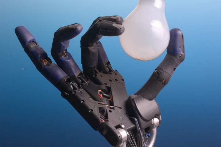 Robot hand holds lightbulb