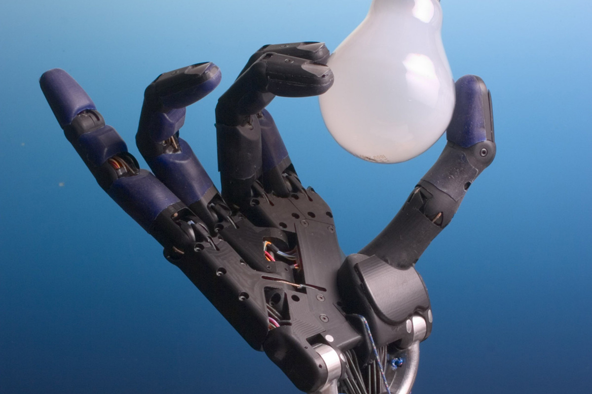 Robot hand holds lightbulb