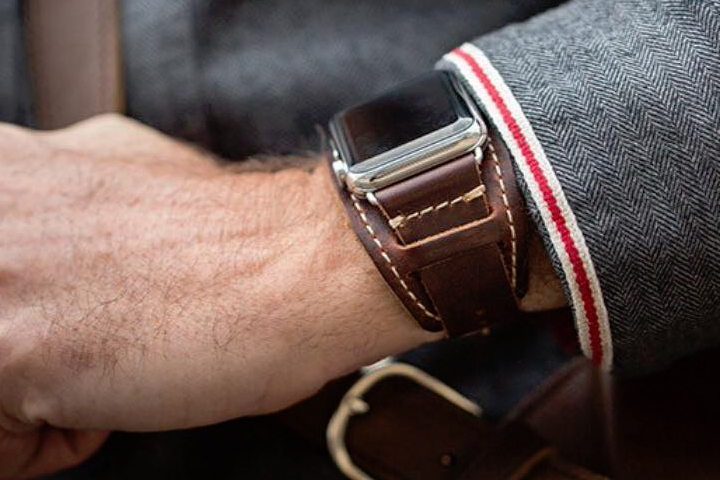 A person wearing the Pad & Quill Lowry Leather Cuff.