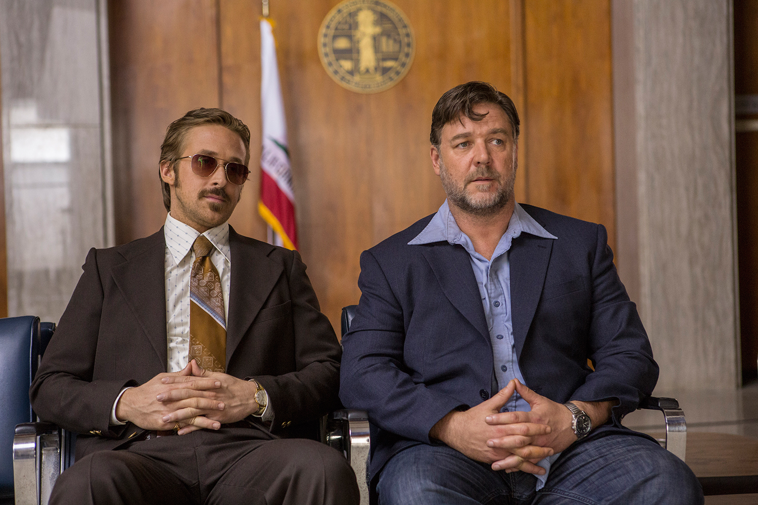 Ryan Gosling and Russell Crowe sit nextto each other in a scene from The Nice Guys.