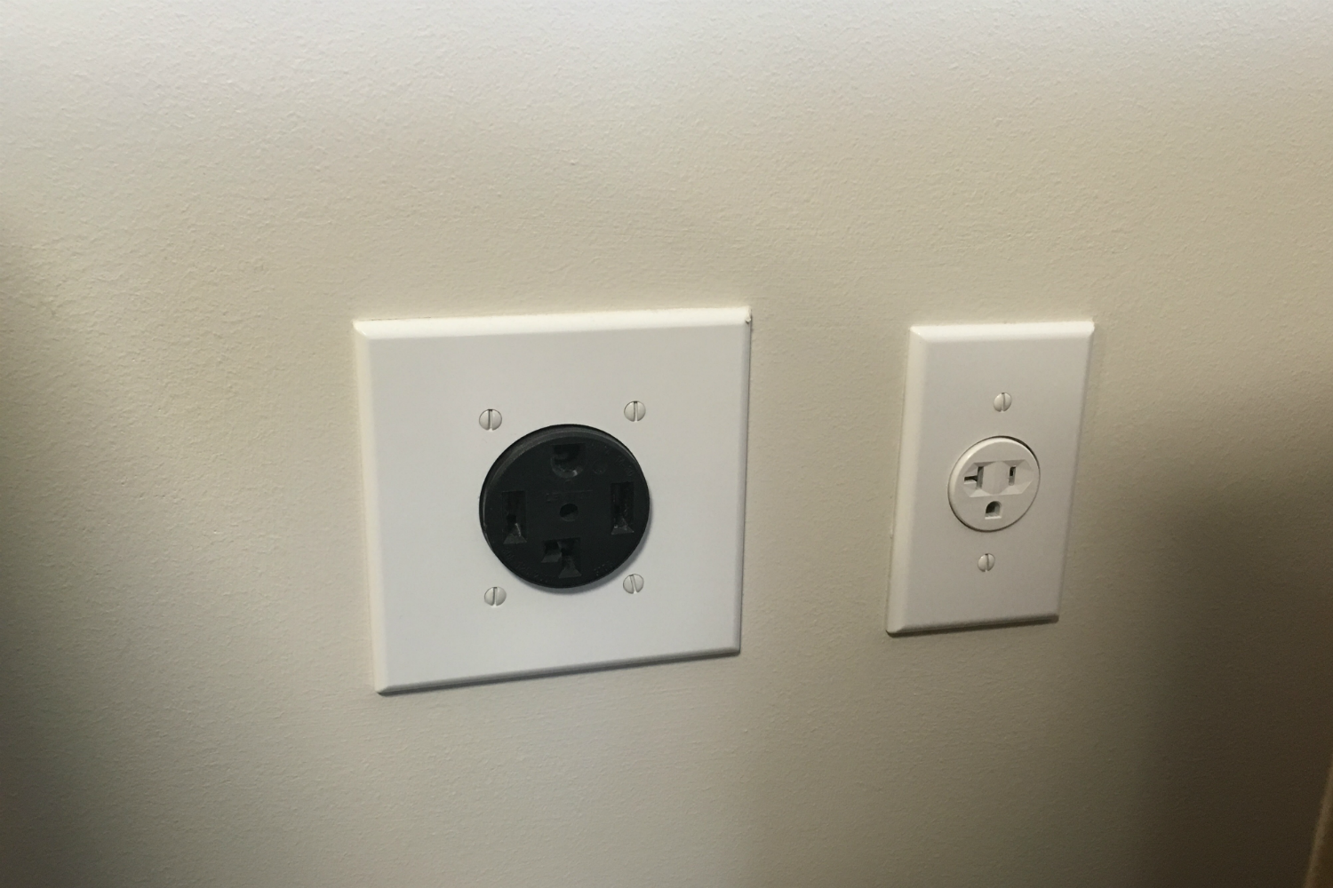 An electric and gas dryer outlet, on the left and right, respectively.