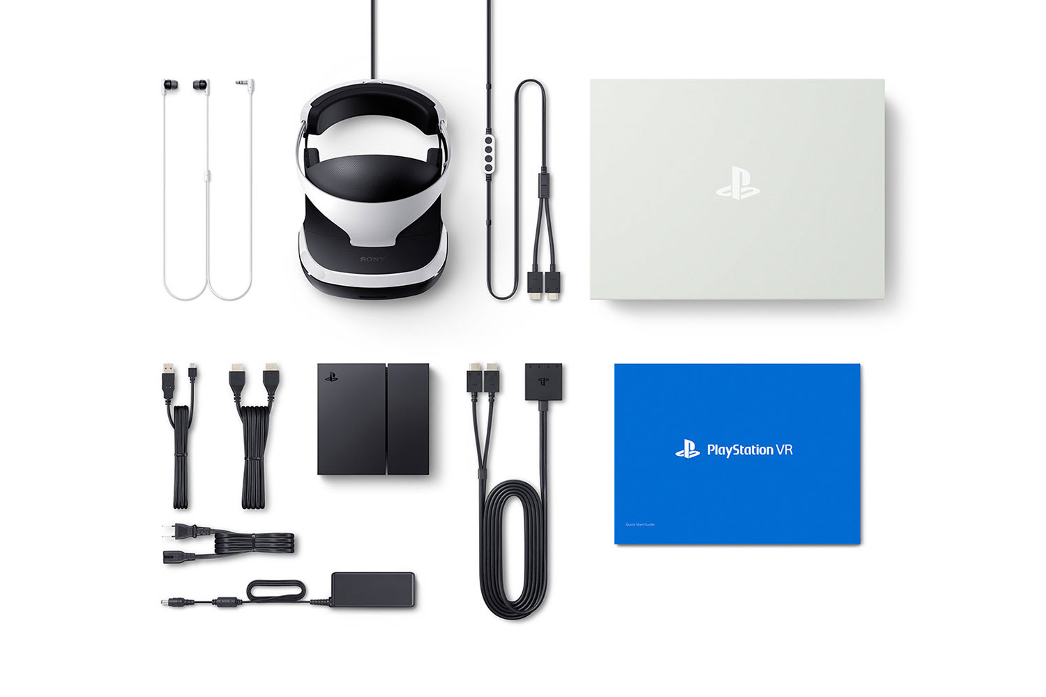 Every component that comes with the PS VR laid out on a table.