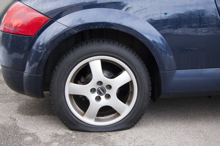 A flat tire on a car.