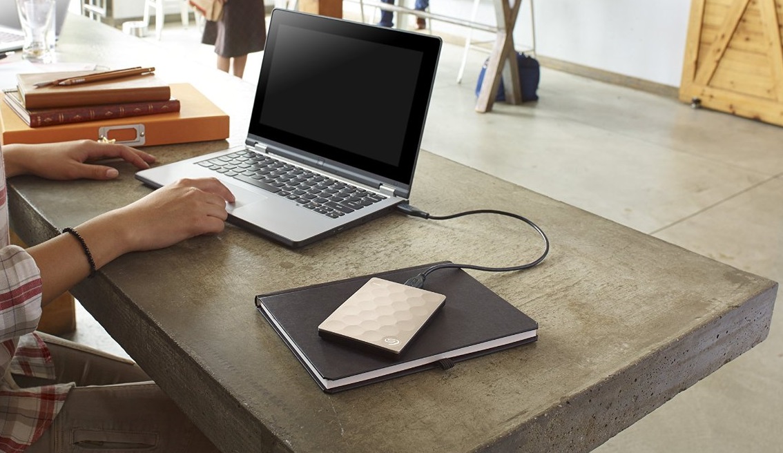 A Seagate external hard drive connected to a laptop.