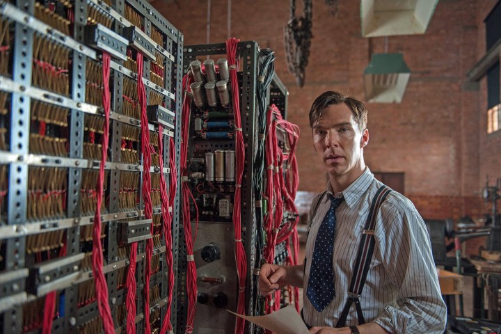 Benedict Cumberbatch stands next to a codebreaking machine in The Imitation Game.