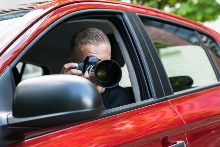 personal profiles databases records private investigators source 41144285  close up of a male driver photographing with slr c