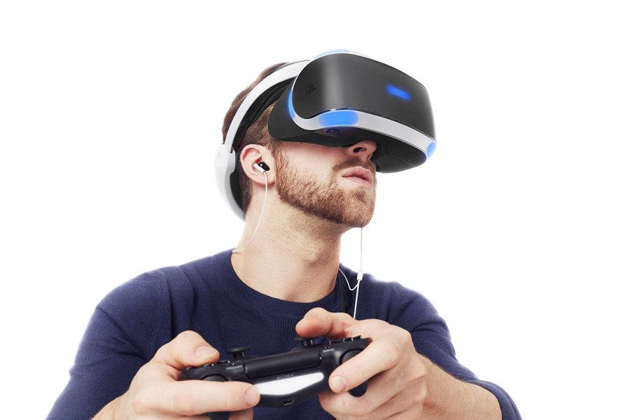 Gamer using vr glasses and controller to play video games. Man with virtual  reality goggles holding joystick in front of computer, playing online game.  Player having fun with games Stock Photo 