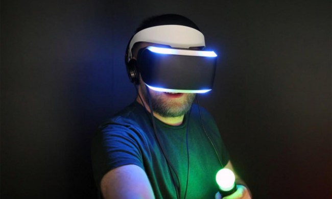 A man playing with a PS VR headset and Move controllers.