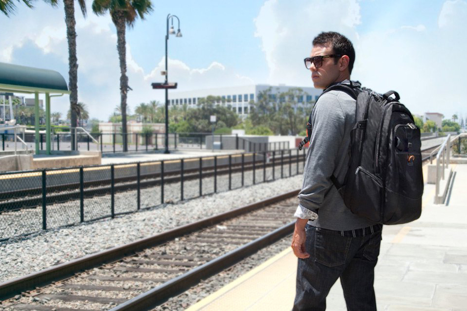 An Everki Titan backpack worn by a man at a station.