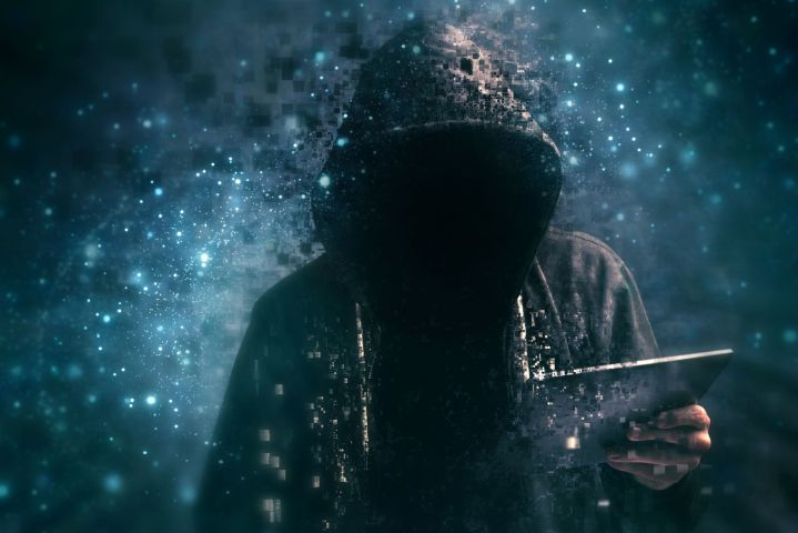 faceless hacker in a black hoody 
