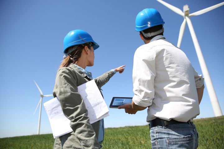wind energy jobs 2016 19821752  engineers looking at turbine site with tablet