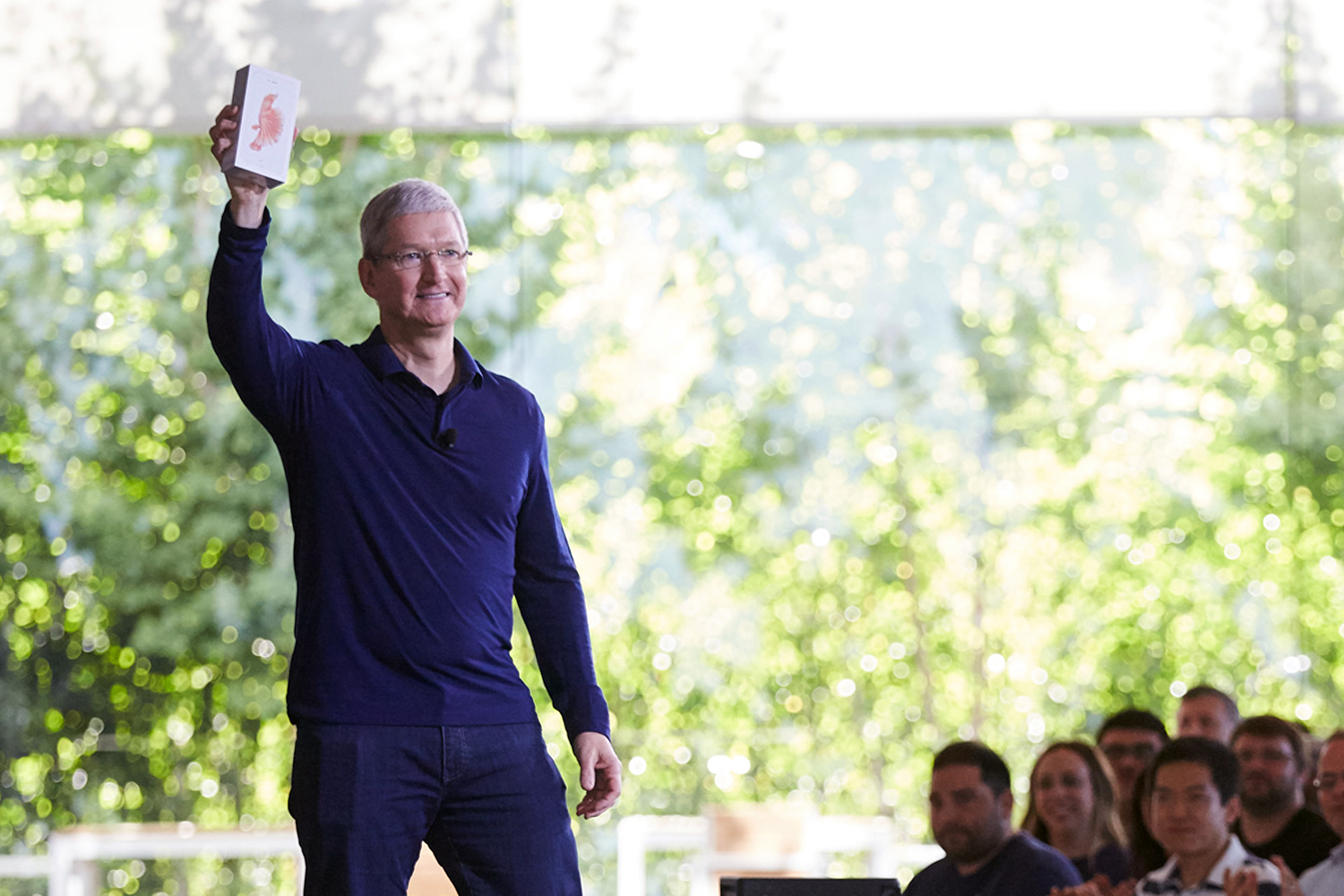 Tim Cook holds the billionth iPhone at an employee meeting in Cupertino.