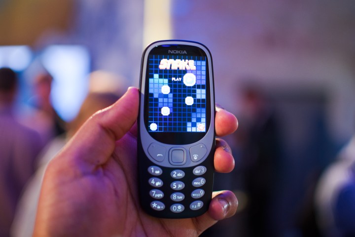 Nokia 3310 in hand.