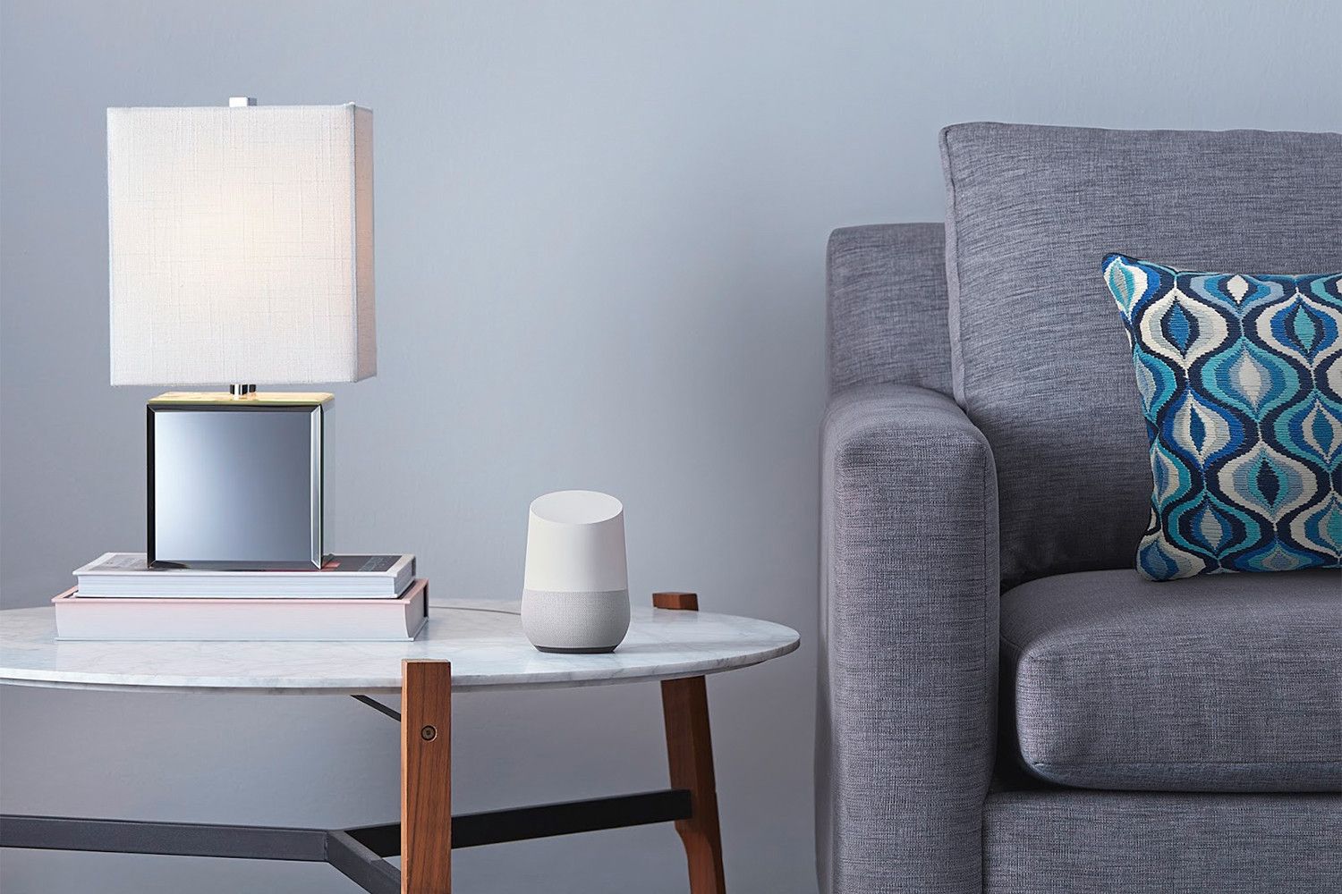 A Google home on a side table by a couch. 