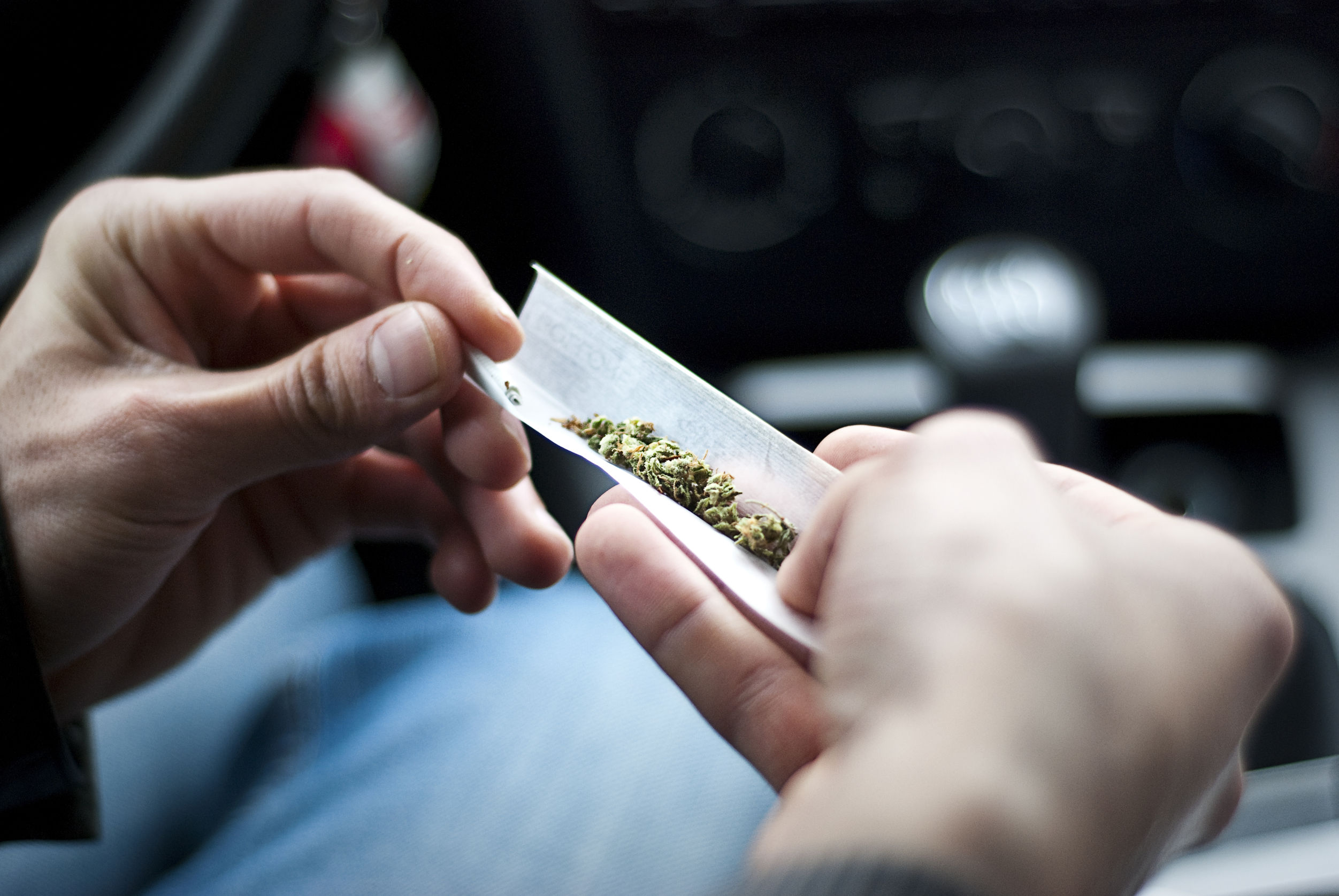 dea synethetic marijuana safer than weed 59953123  man making joint and a stash of in the car