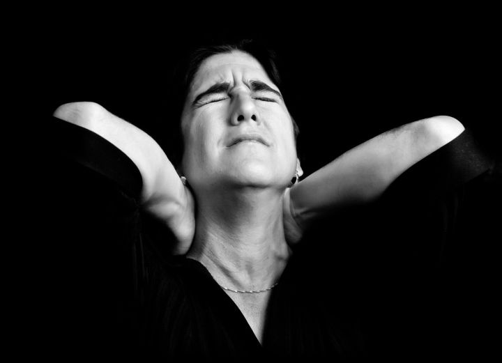 text neck smartphone black and white portrait of a stressed woman suffering from pain