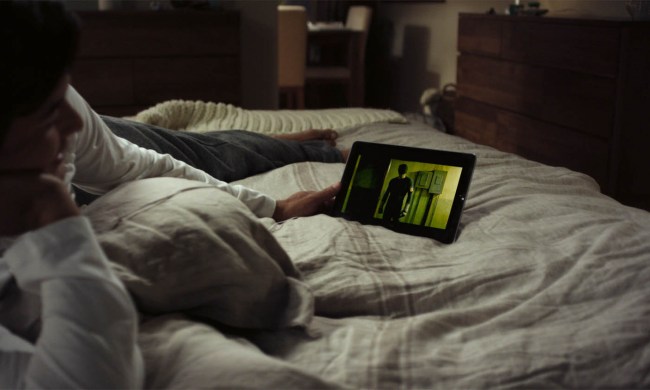 Someone watching Netflix on a tablet in bed.