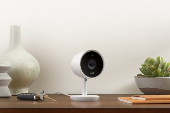Nest Cam IQ sitting on a desk next to car keys and books