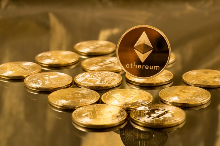 Ethereum coins sitting on a desk.
