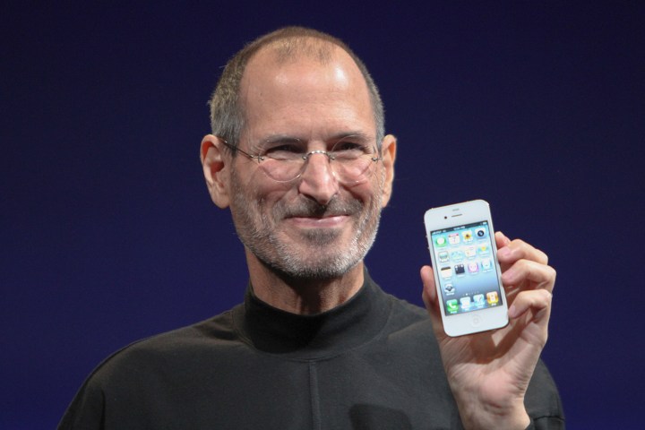 Steve Jobs holding an iPhone.