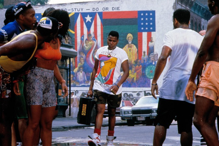 Mookie walks down the street in Do The Right Thing.