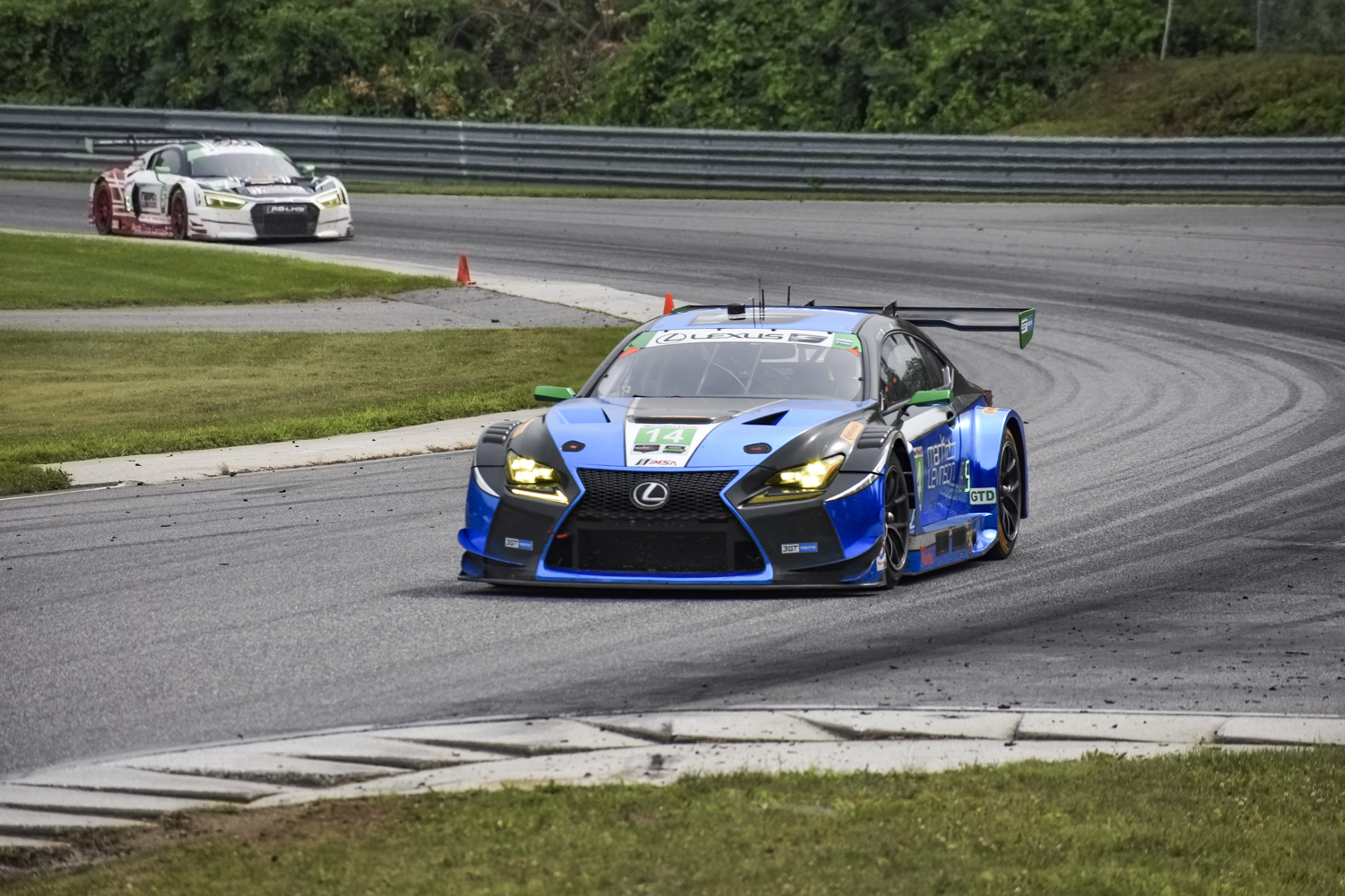 Shot of the Lexus RC F GT3 turning a corner ahead of another car