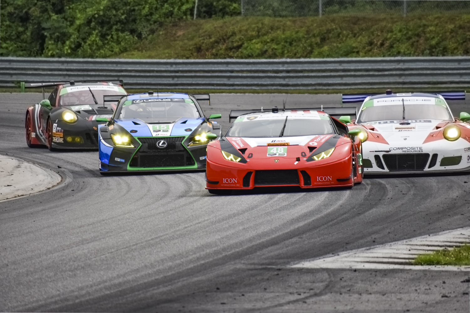 Racing shot showing the Lexus RC F GT3 making a pass (in third place)