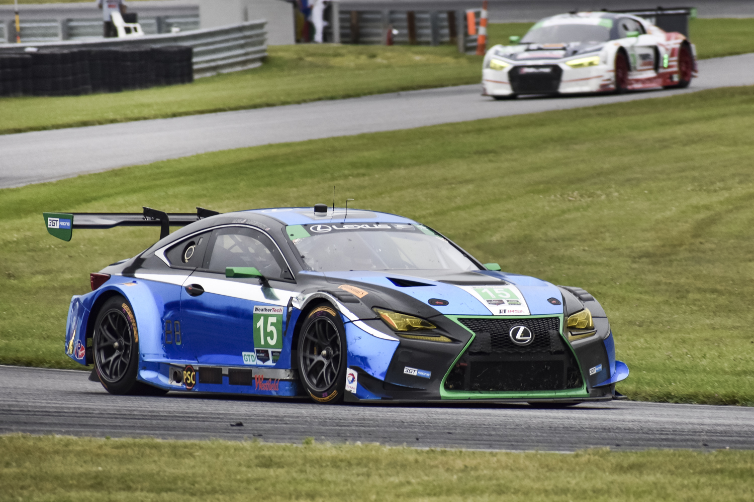 Side shot of the Lexus RC F GT3 on the track with another car in the background