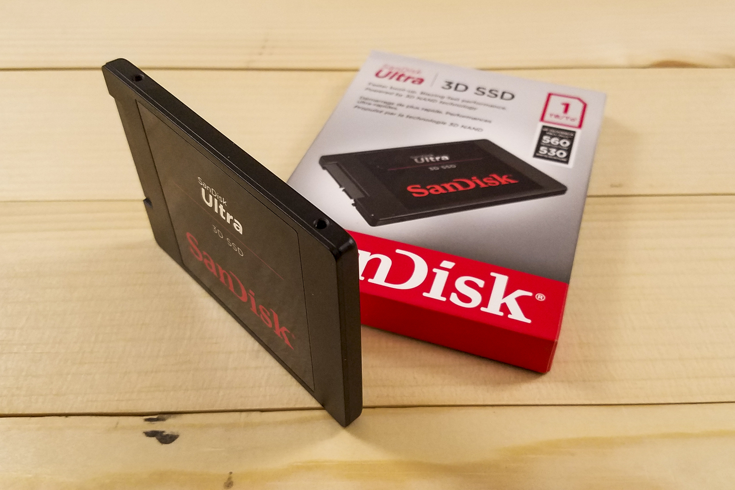SanDisk Ultra 3D SSD sitting next to the box it comes in