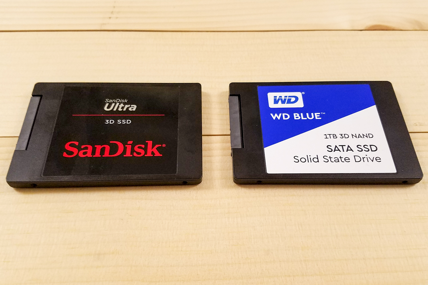 WD Blue 3D NAND SATA SSD and SanDisk Ultra 3D SSD sitting side-by-side aligned horizontally