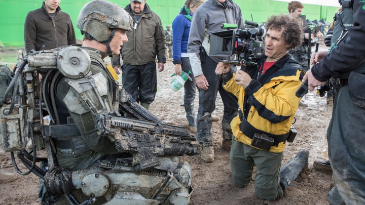 Doug Liman on the set of The Edge of Tomorrow filming actor Tom Cruise's character in the mud