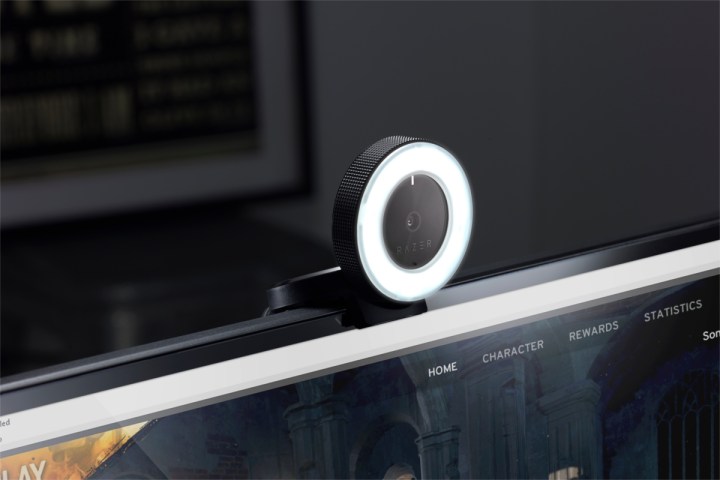 A webcam with a ring light on top a PC.
