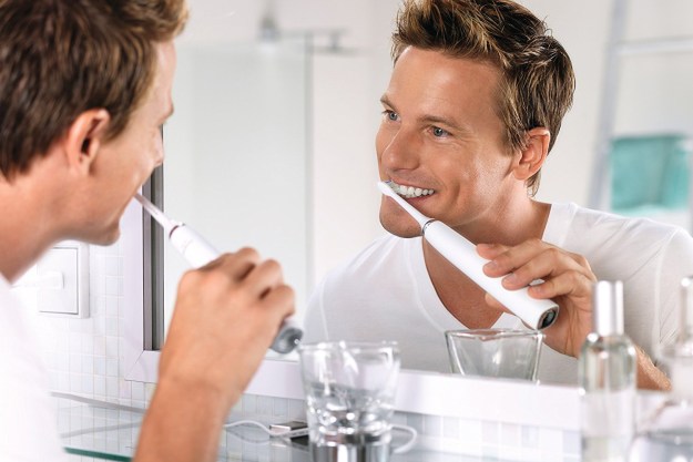 A man using the Philips Sonicare DiamondClean electric toothbrush.