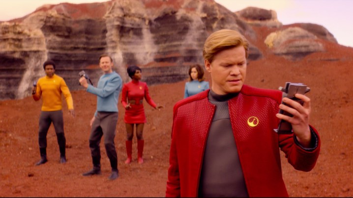 A space crew stand on a planet in The Black Mirror's USS Callister episode.