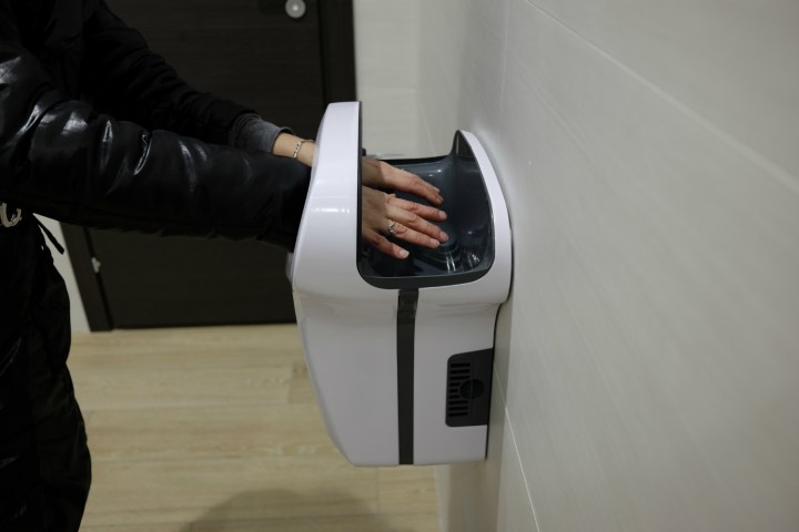 Hands in hot-air hand dryer