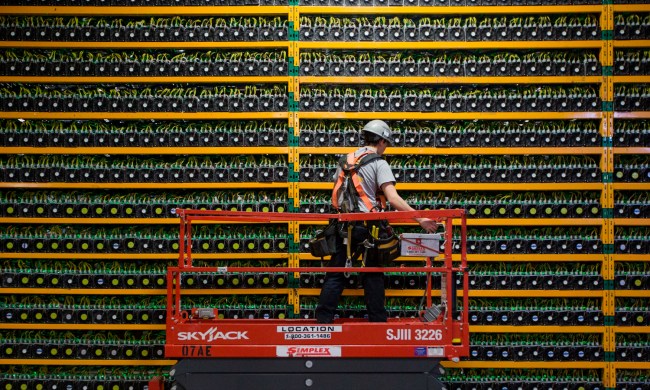 A technician inspects the backside of bitcoin mining at Bitfarms in Saint Hyacinthe.