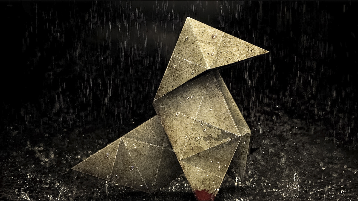 Uma figura de origami no chão sob a chuva.