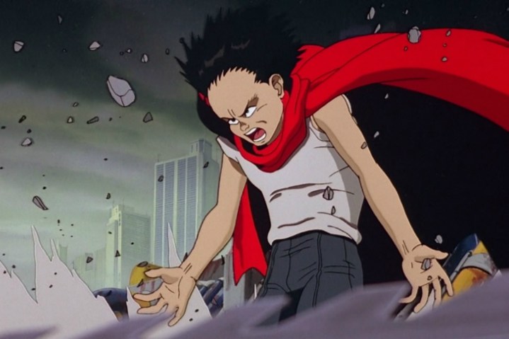 A boy with a cape conjures his powers in Akira.