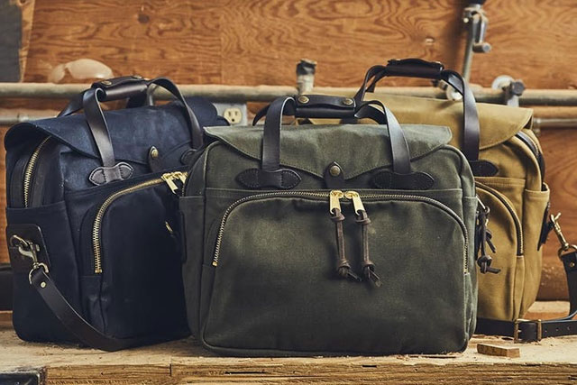 Group of three Filson Padded Computer Bags in various colors.