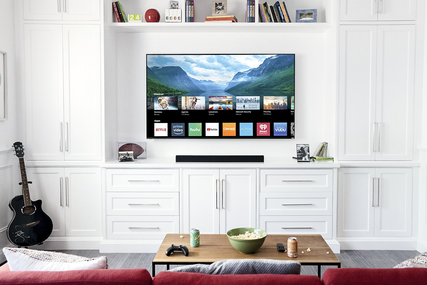 A wall-mounted Vizio TV in a white room.