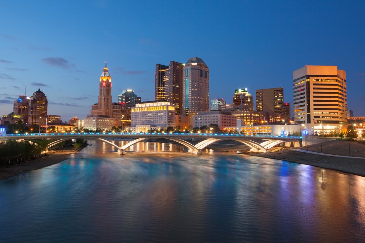 Columbus, Ohio skyline and Scioto River at night.
