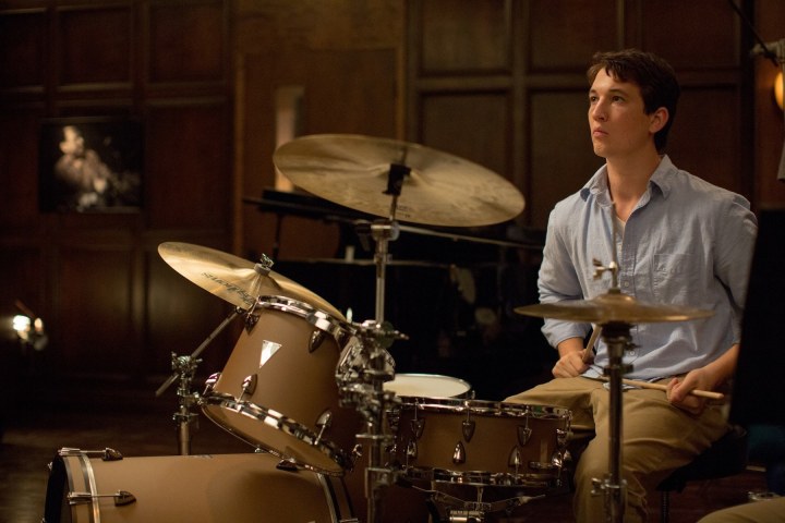 Miles Teller sits at a drum kit in Whiplash.
