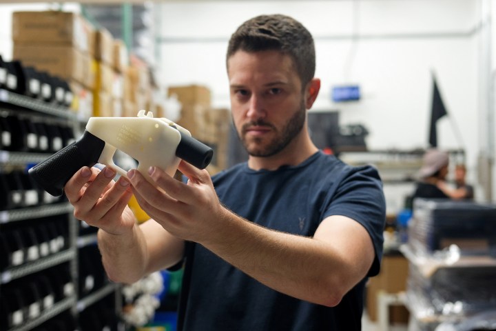 Cody Wilson, owner of Defense Distributed company, holds a 3D printed gun