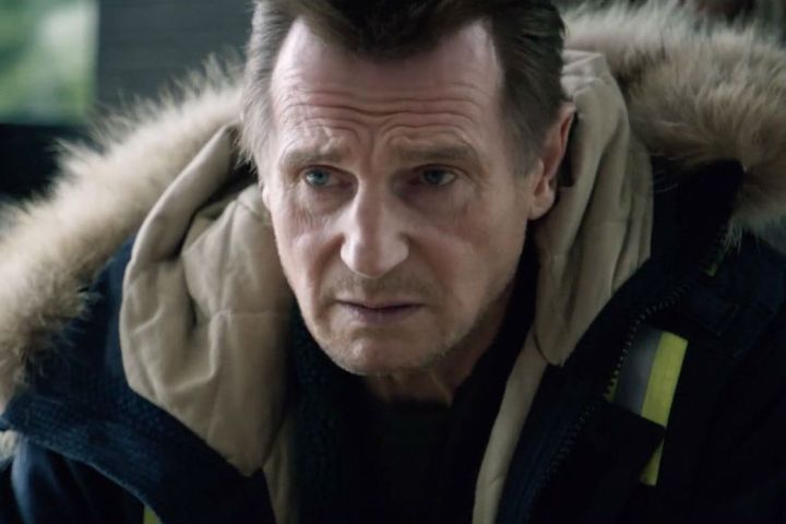 Liam Neeson stares while wearing a coat in Cold Pursuit.