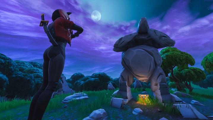 fortnite week 5 challenges search between a giant rock man crowned tomato and encircled tree