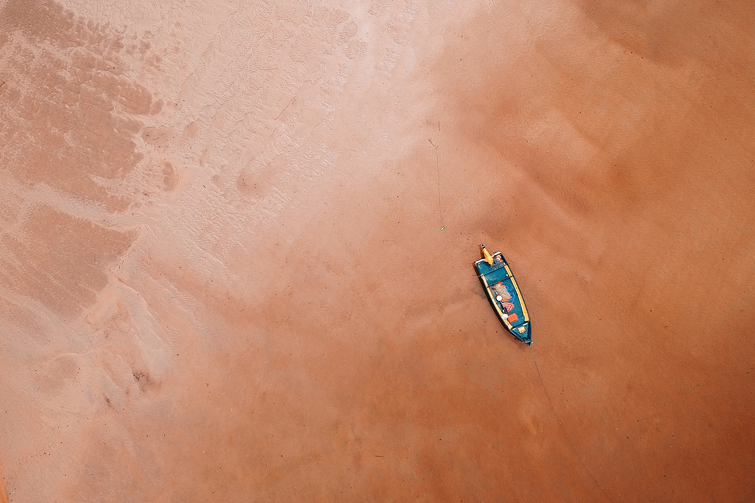 best drone photos directly above shot of rowboat on sand at beach