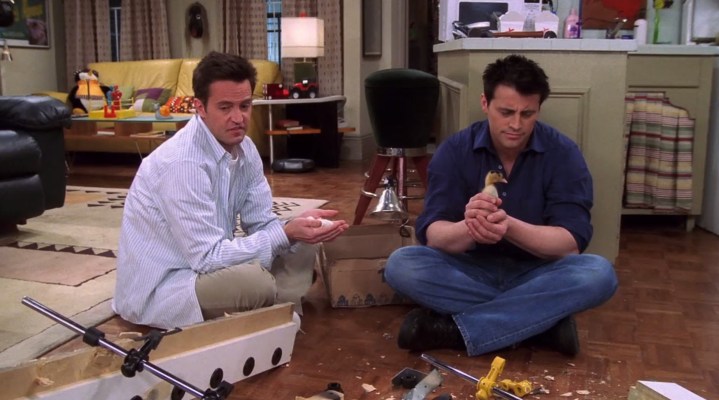 Joey and Chandler are sitting on the floor in Friends.